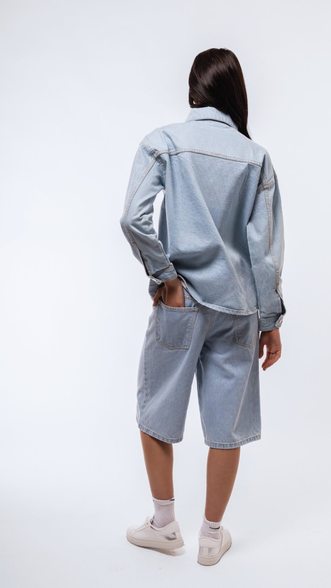 Back image of casual denim wash longline shirt with dropped shoulder and washed texture.