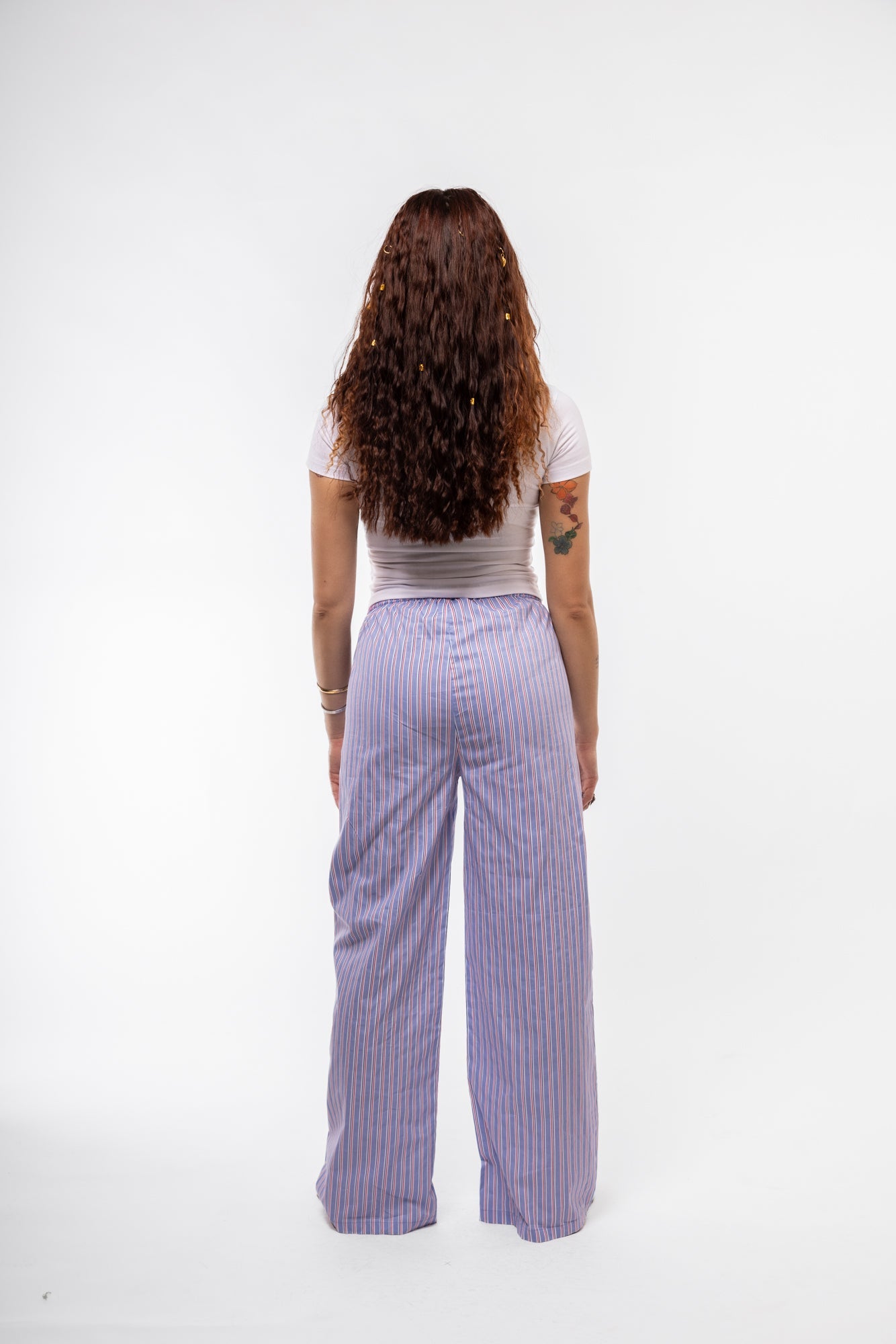 Back profile of blue stripe trousers designed for everyday comfort.