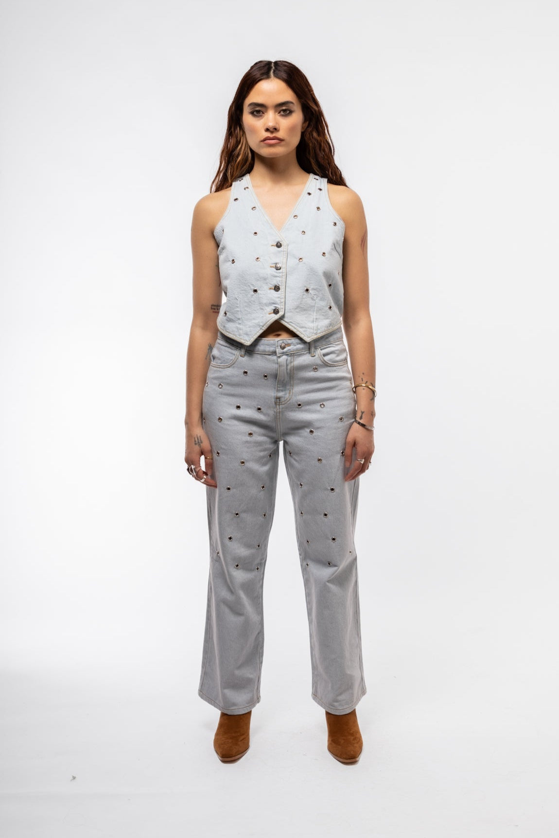 Back view of high-waisted studded jeans with relaxed wide-leg fit and structured silhouette