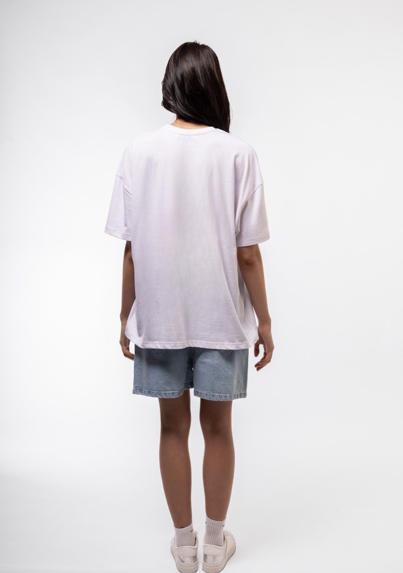 Back view of oversized tee highlighting streetwear styling and minimal back design