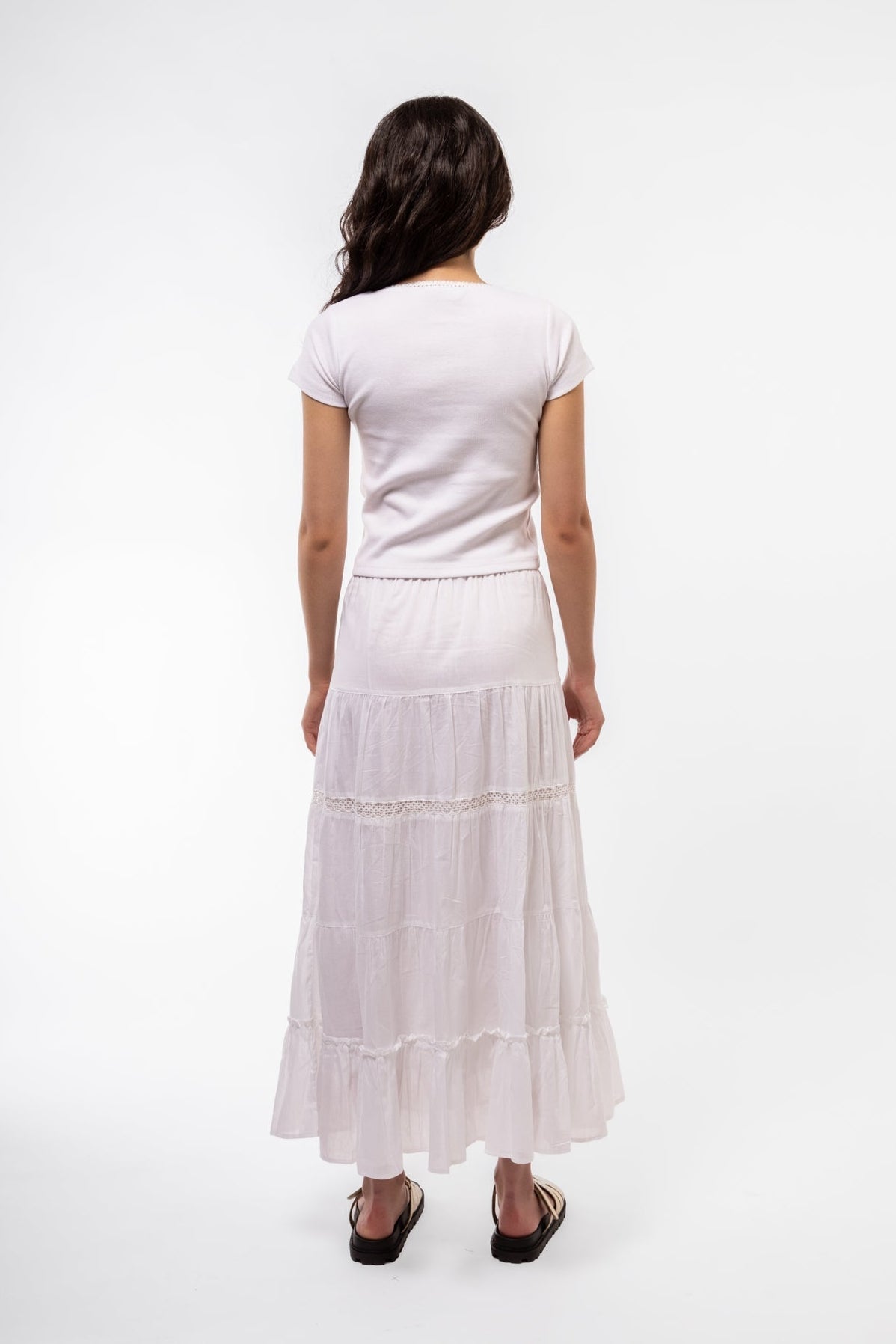 Back view of white scoop neck top featuring smooth panel and body-skimming fit