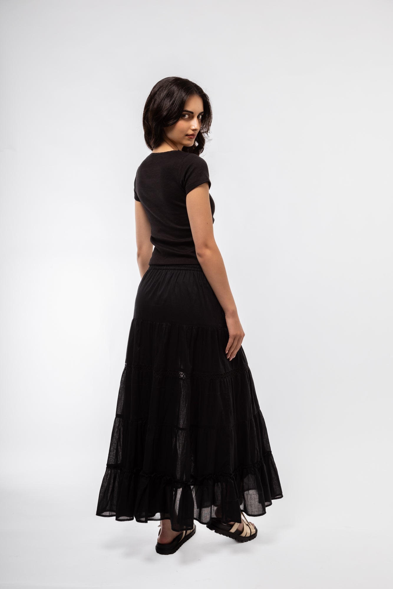 Black boho skirt side view emphasizing elastic waistband and bohemian-inspired detailing