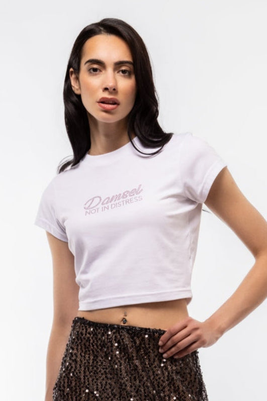Close-up front image of “Damsel Not in Distress” tee highlighting glittering text and soft cotton fabric