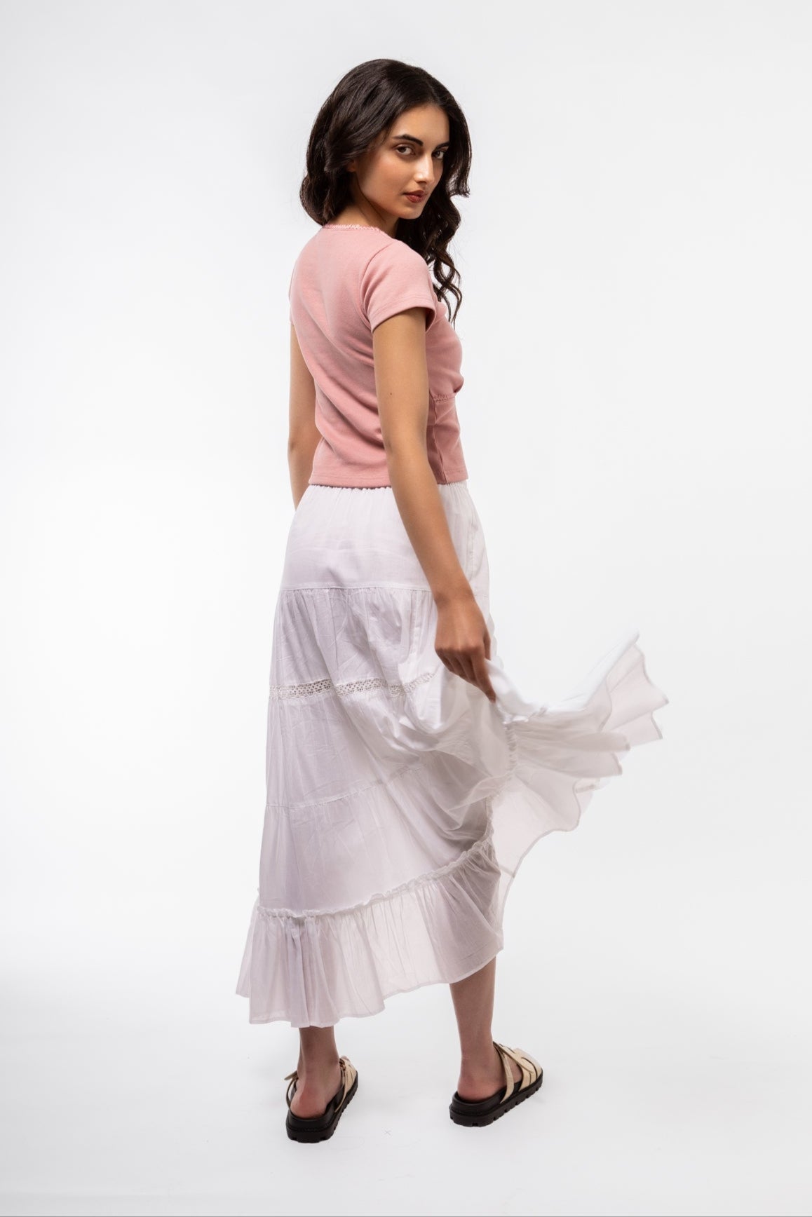 Close-up front image of white boho skirt highlighting lace trim and relaxed fit
