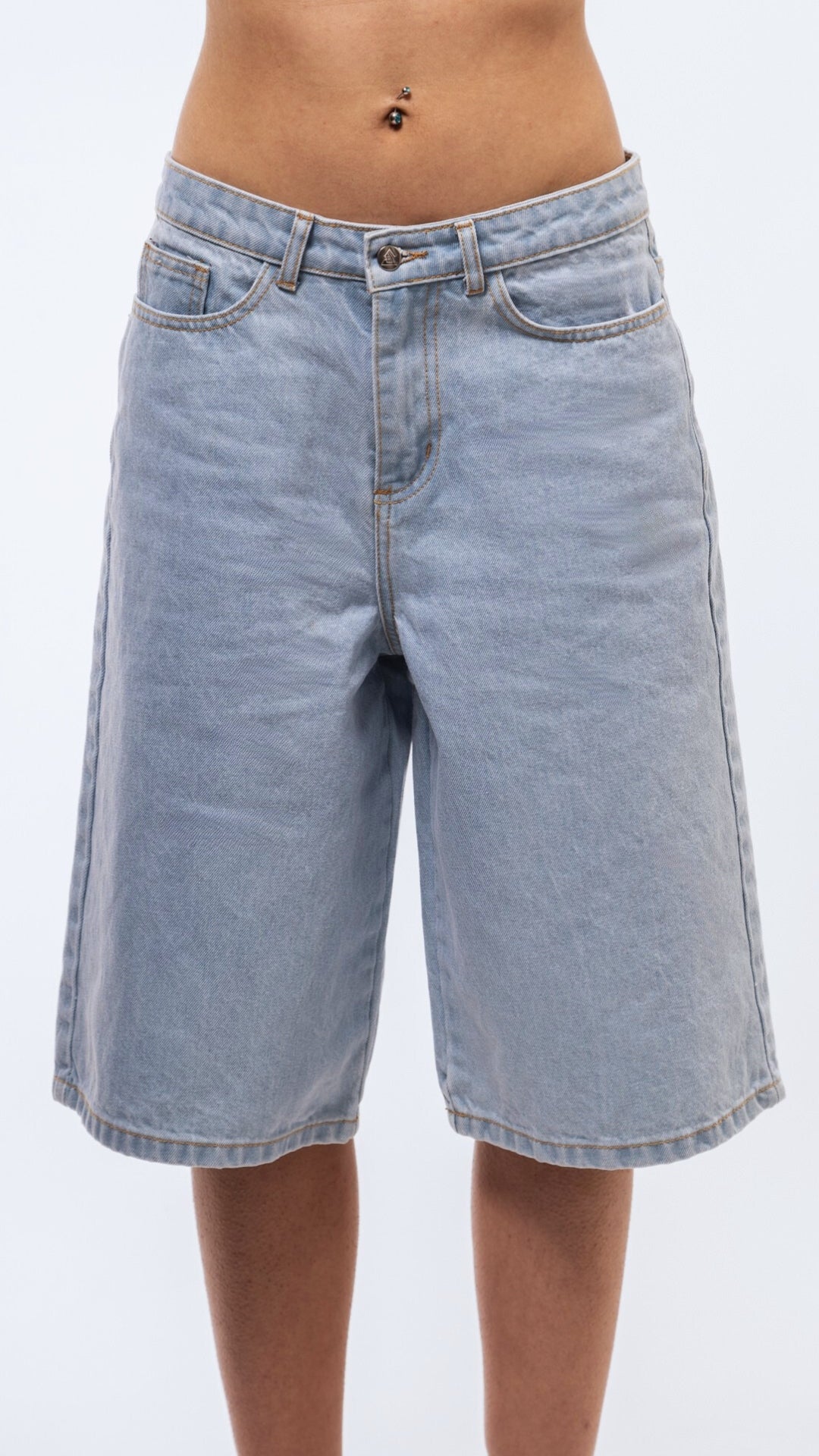 Front view of casual longline jorts in mid-wash denim with structured seams and relaxed leg.
