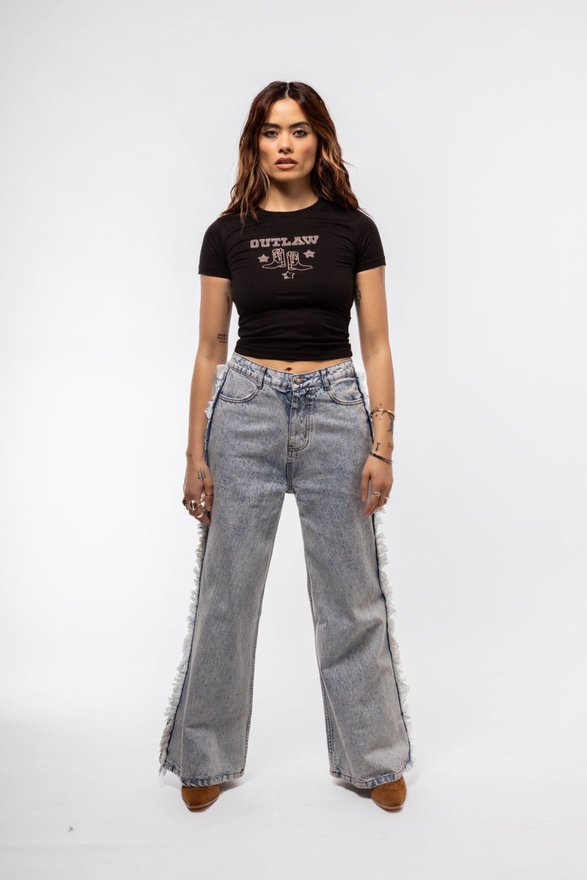 Front view of fringe denim jeans featuring distressed fringe detailing and classic five-pocket design