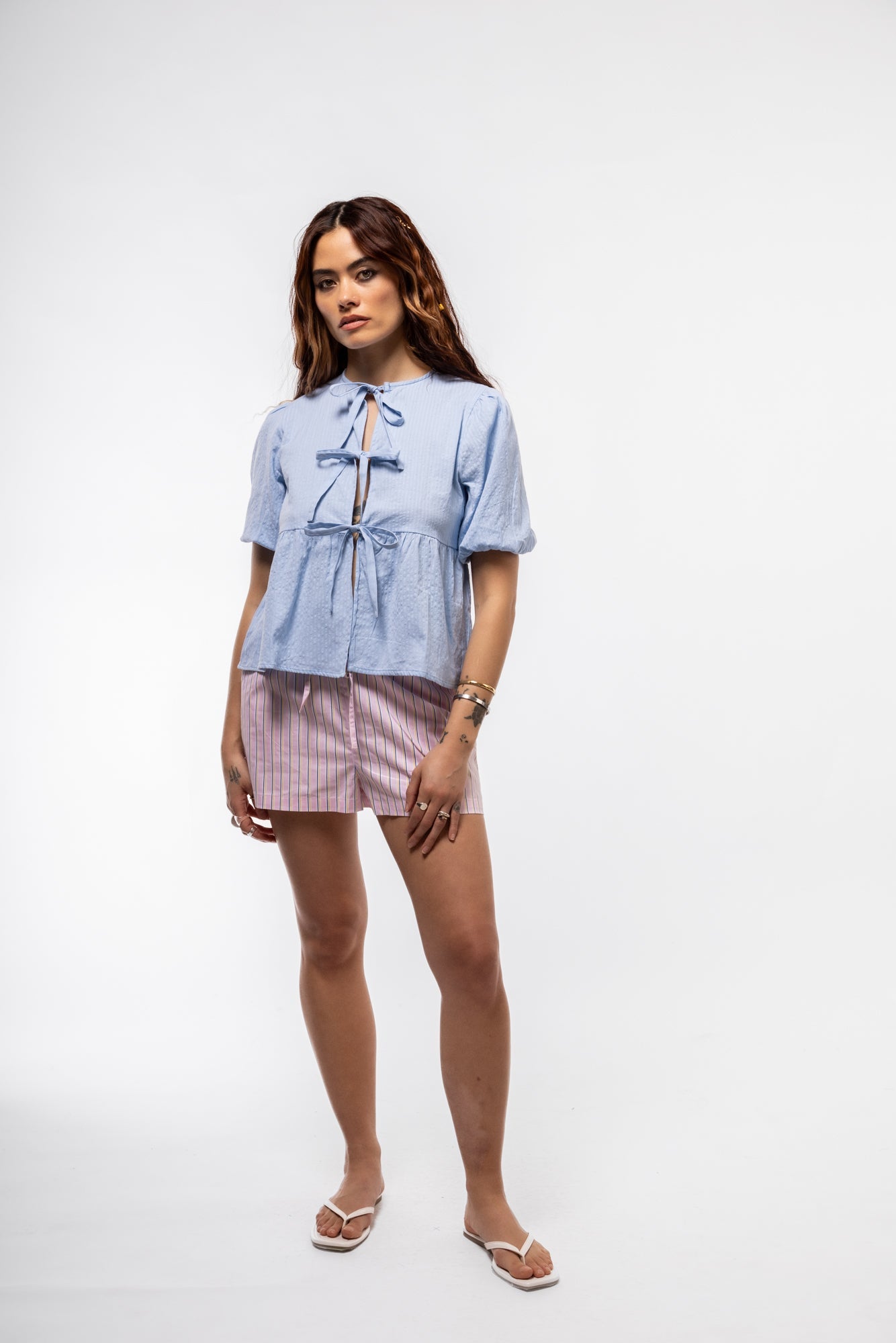 Front view of light blue puff-sleeve cotton top with front tie