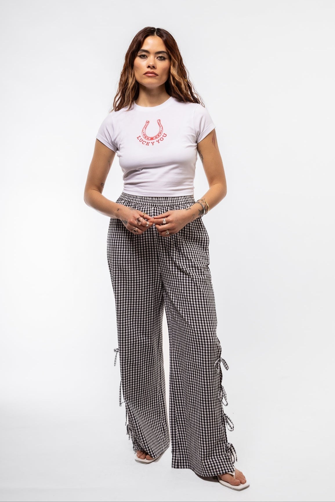 Front view of the black gingham side details trousers in black