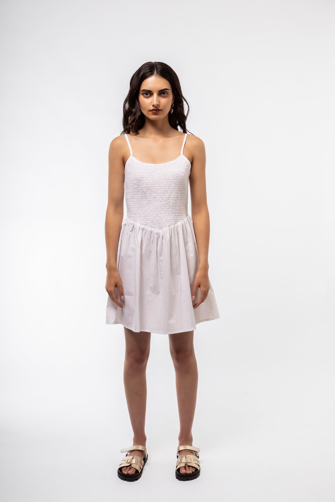 Front view of the white shirring v mini dress
