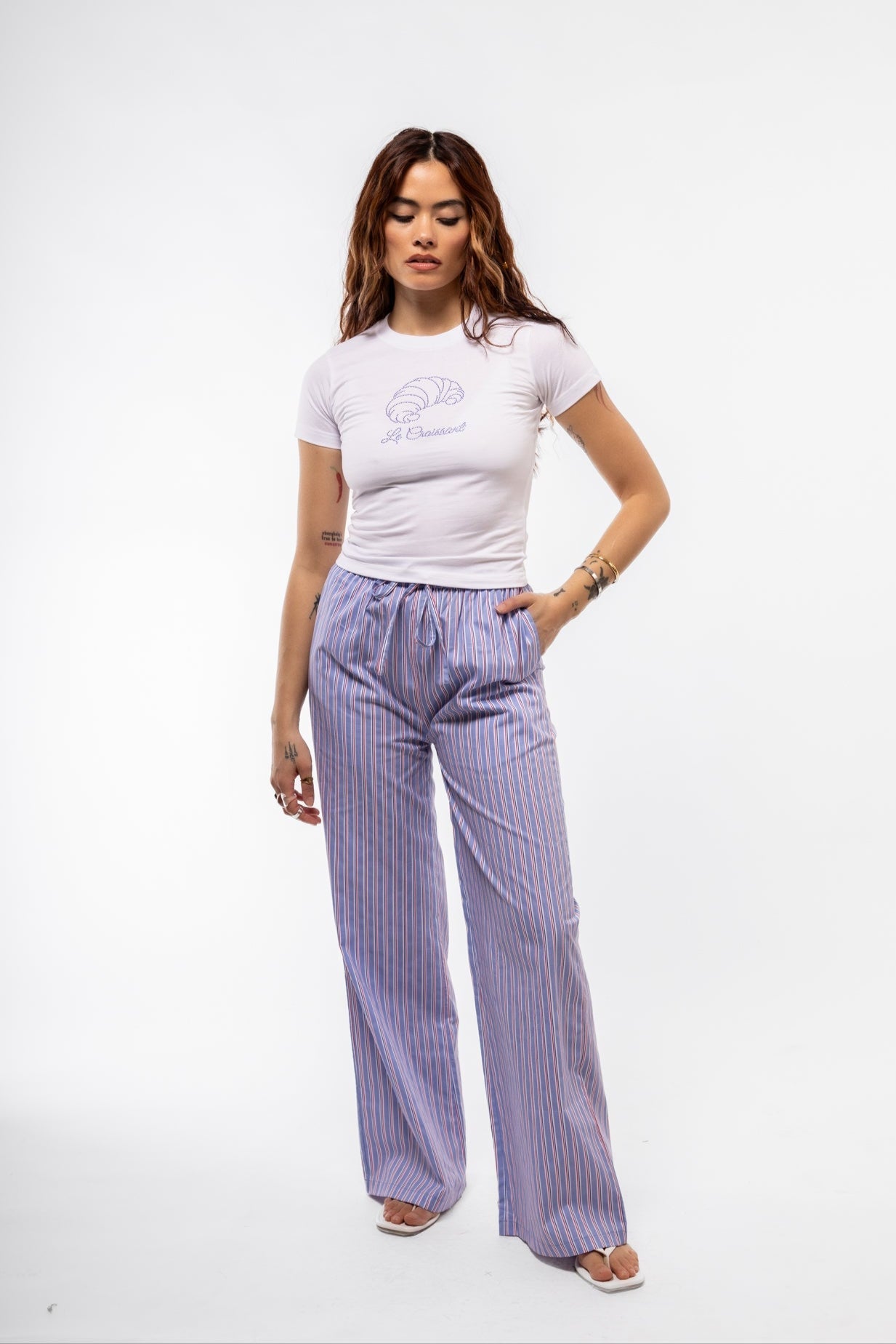 Front view of women's blue striped cotton trousers with drawstring waist, perfect for casual summer