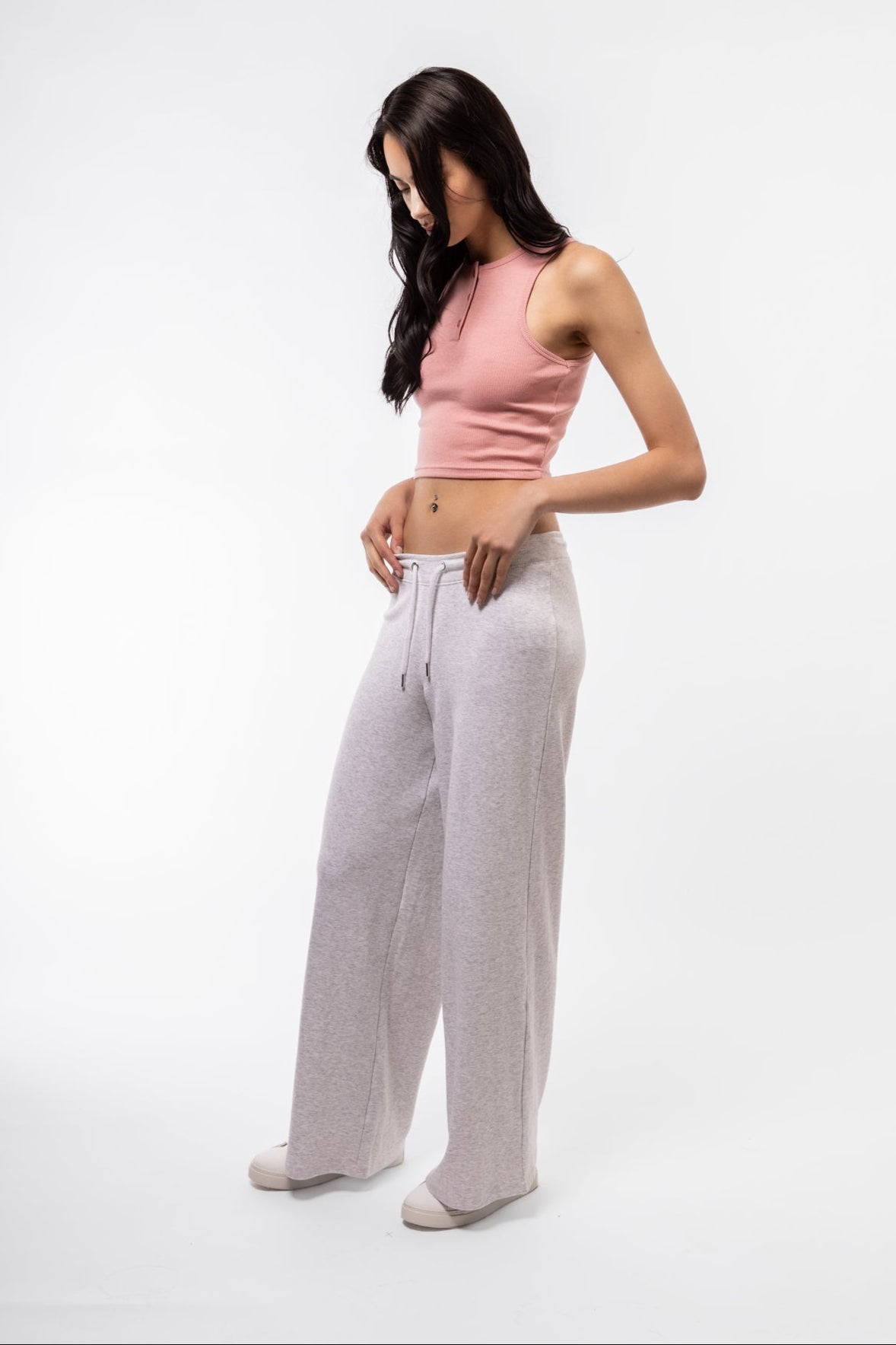 Light pink racer top side profile highlighting cropped length and fitted design.
