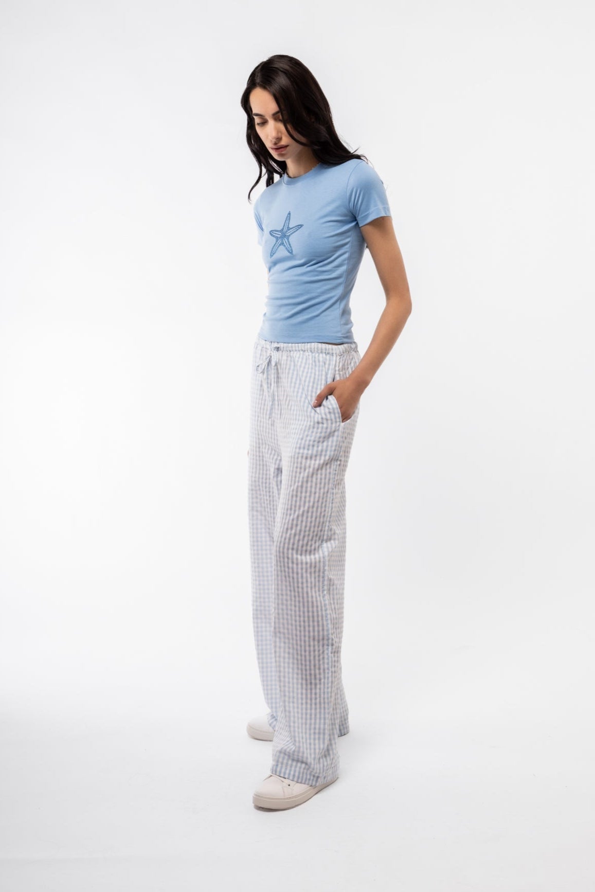 Women’s soft cotton gingham trousers in blue, side view highlighting flattering fit.
