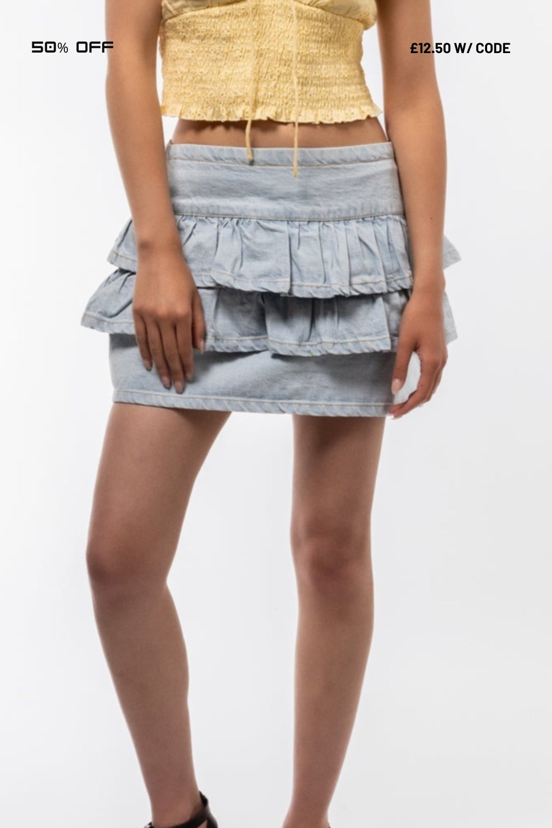 wearing a layered denim skirt on a white background