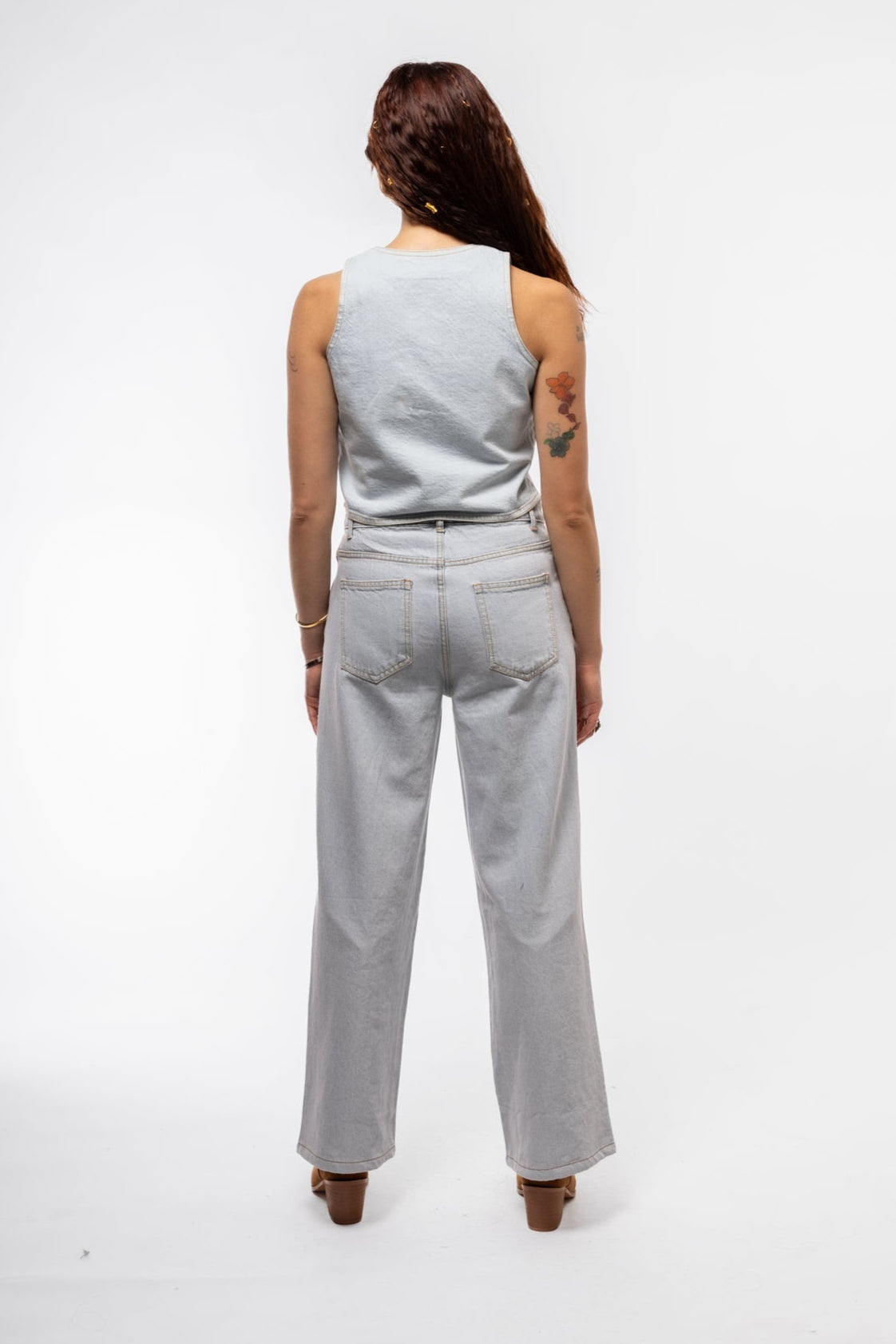 Rear image of wide leg jeans showcasing back yoke, minimalistic stitching, and subtle stud details