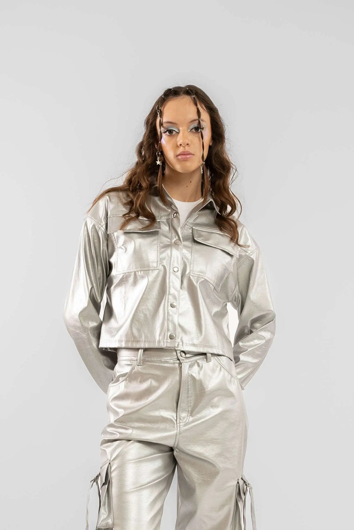 a woman showing the silver coated faux leather trucker jacket