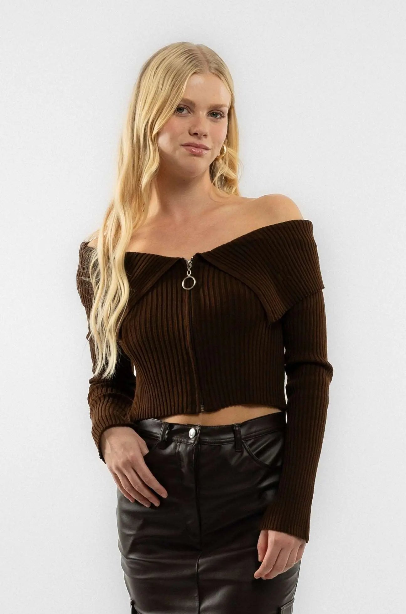 a woman wearing a brown knitted zip through top