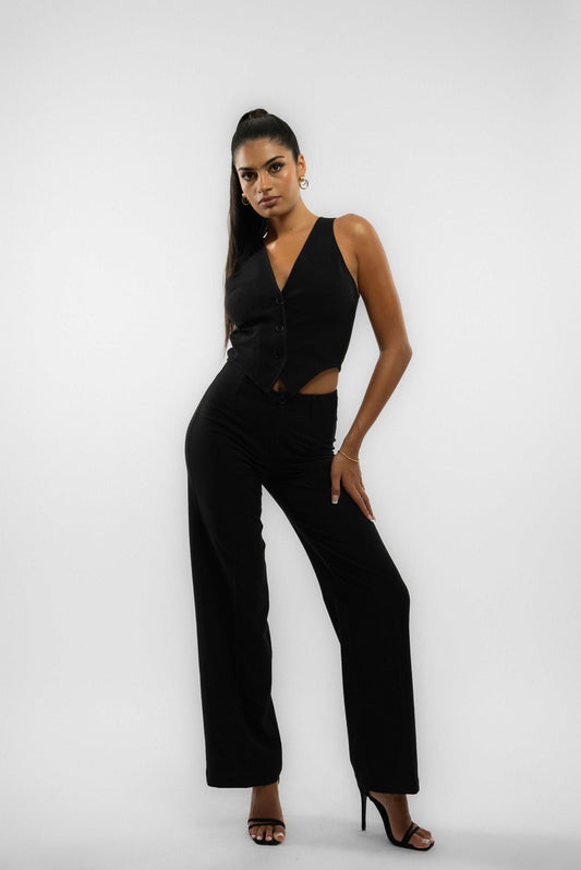 a woman in a black tailored wide leg trouser posing