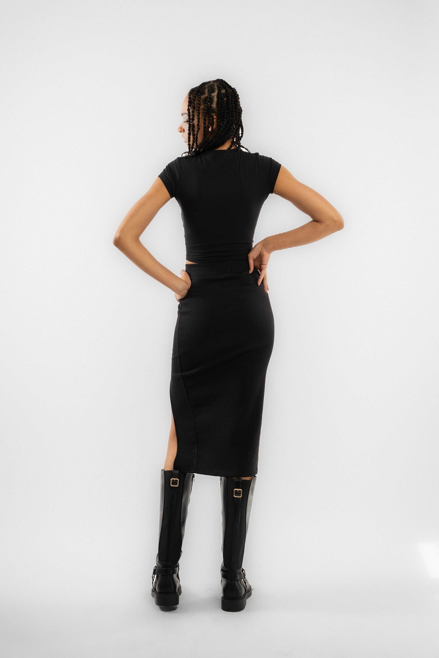a woman posing wearing a black slit skirt silkroad daughters