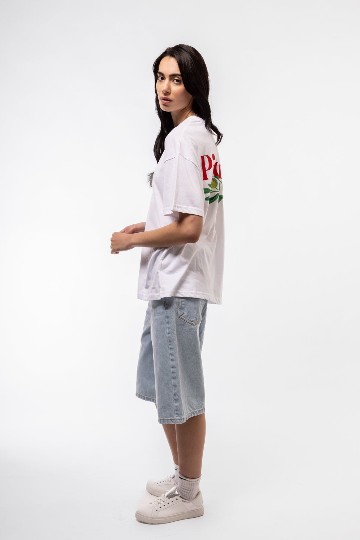 Side profile of Olive Branch oversized tee showing loose fit and extended sleeves