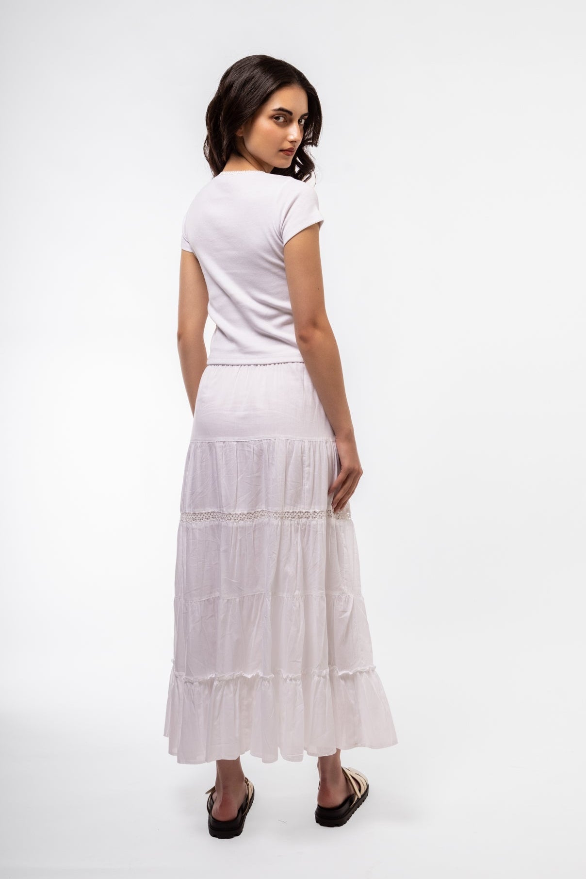 Side shot of white lace-trim top with soft stretch and sleeveless edge