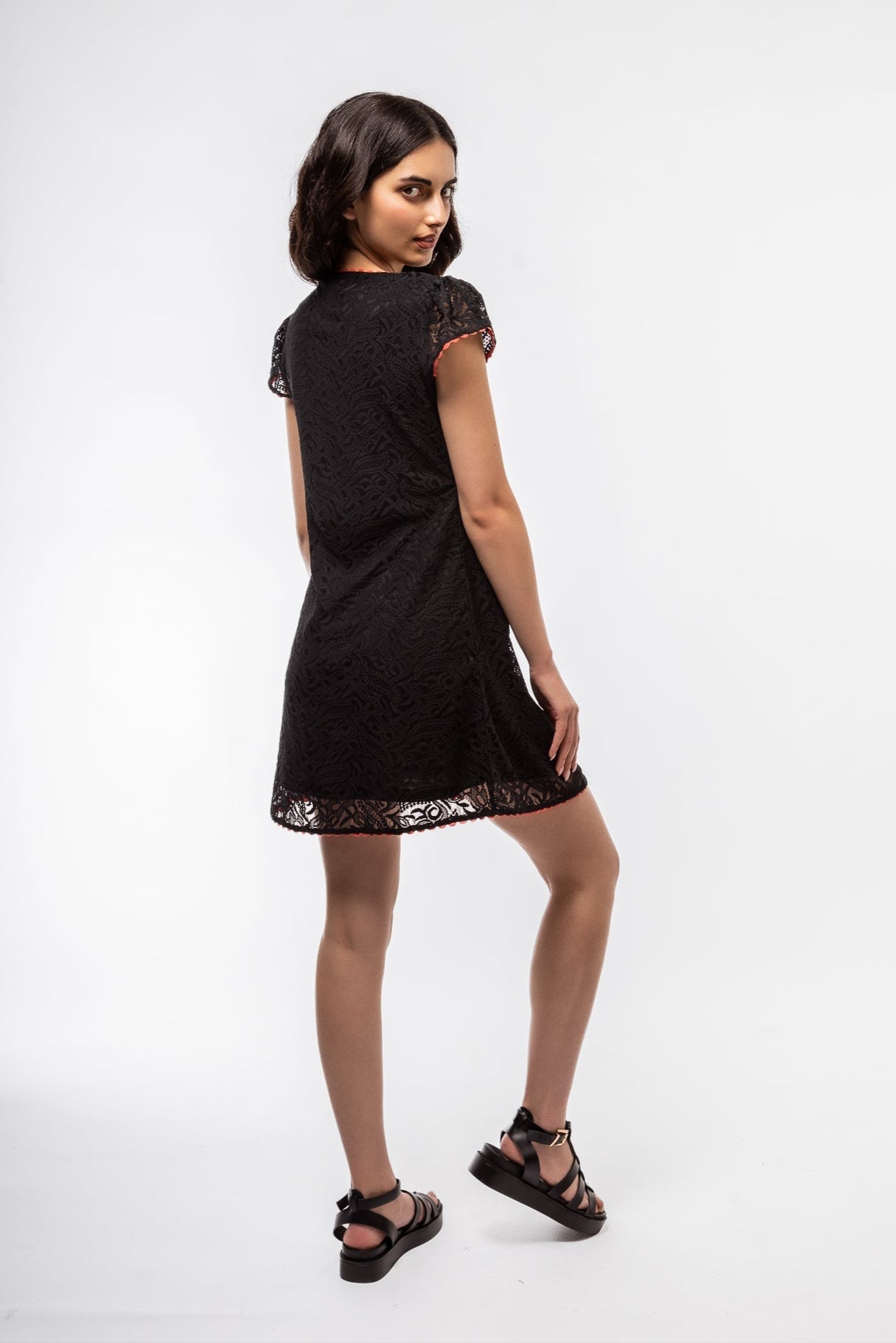 Side view of the bLack Lace Mini Dress in Black