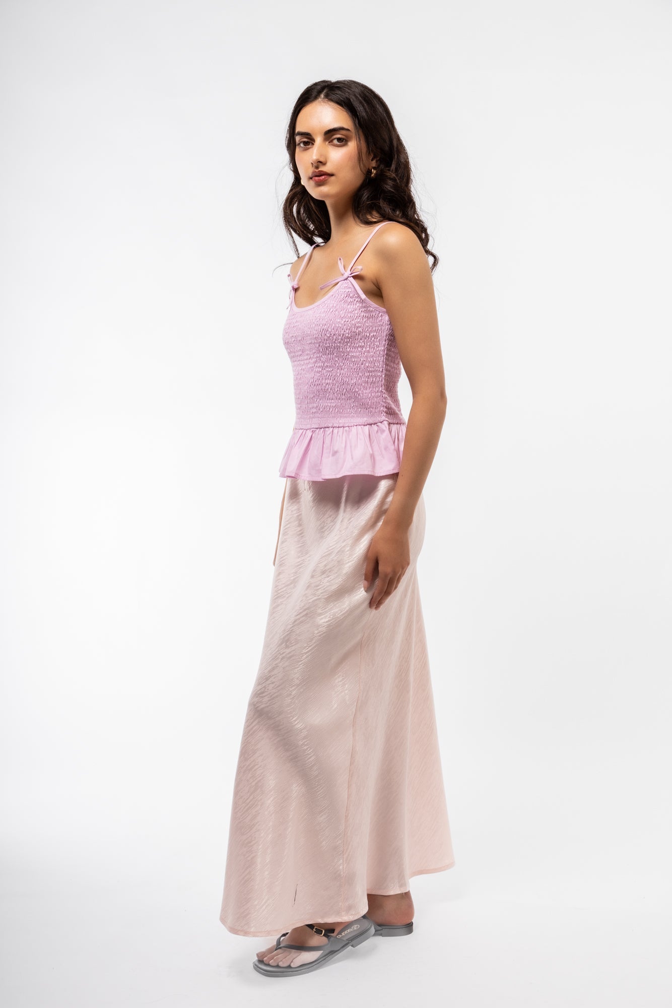 Side view of the pink jacquard midi skirt
