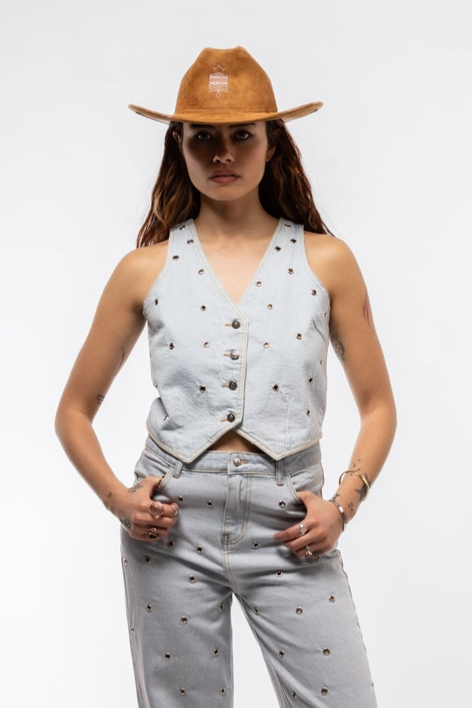 Sleeveless denim vest with metallic studs, structured collar, and chest pocket details