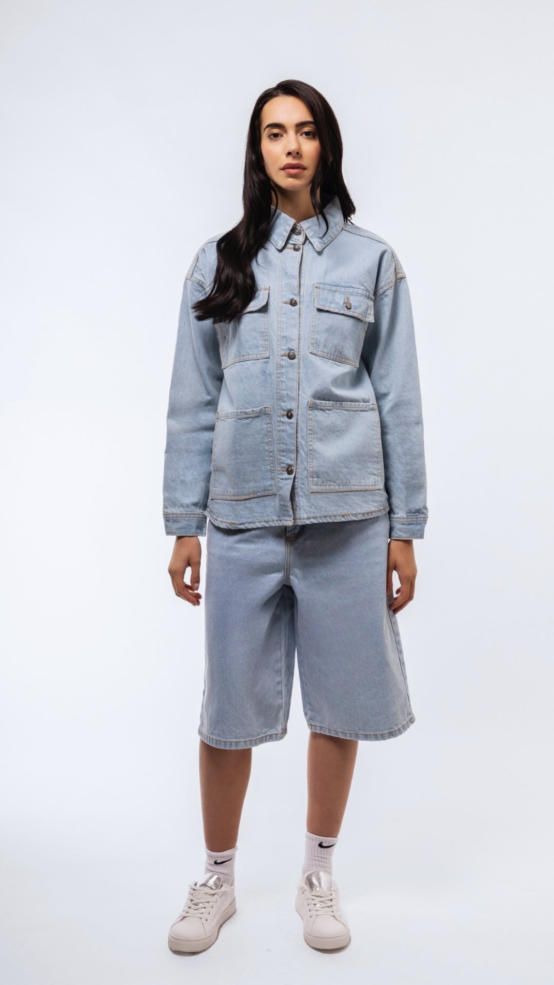 Women’s denim wash longline shirt front shot with classic collar and curved hem.
