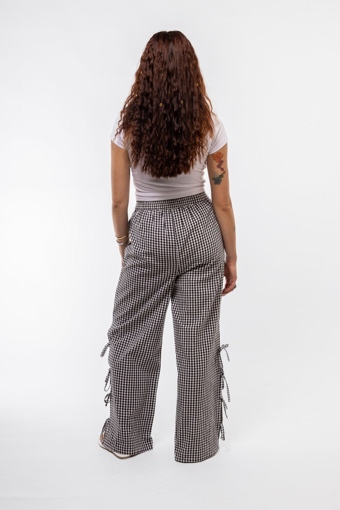 back view of the black gingham trousers with side bows