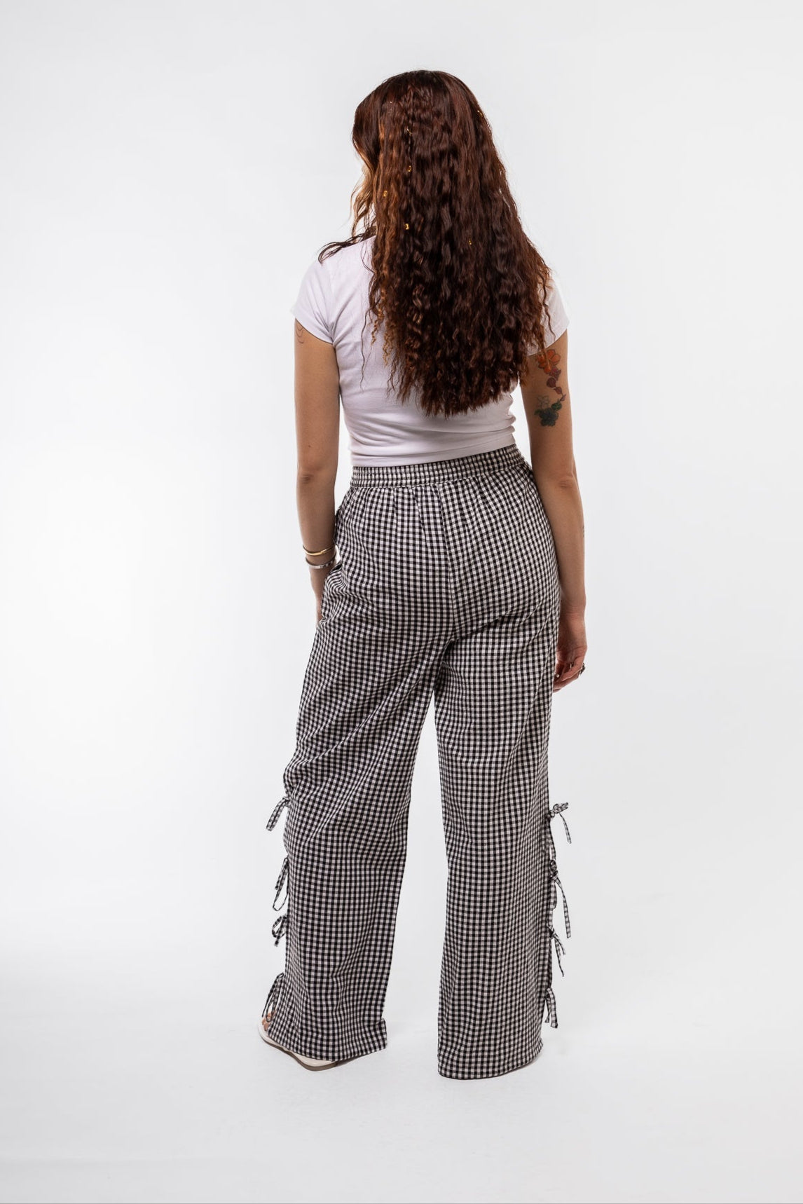 back view of the black gingham trousers with side detail bows
