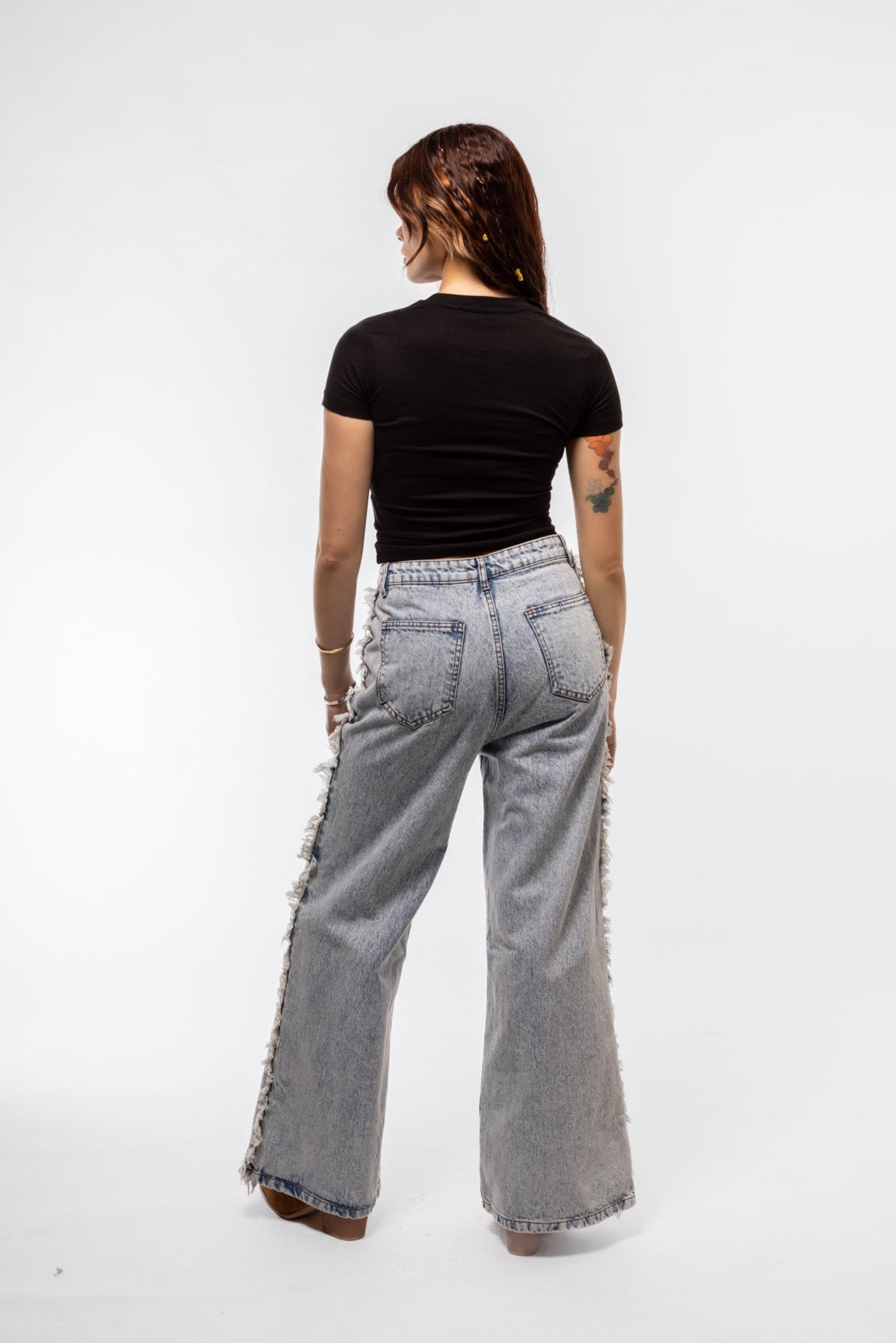 back view of the denim fringe denim jeans