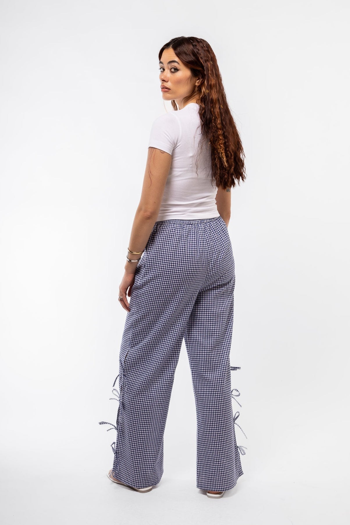 profile view of the blue gingham trousers with side bows