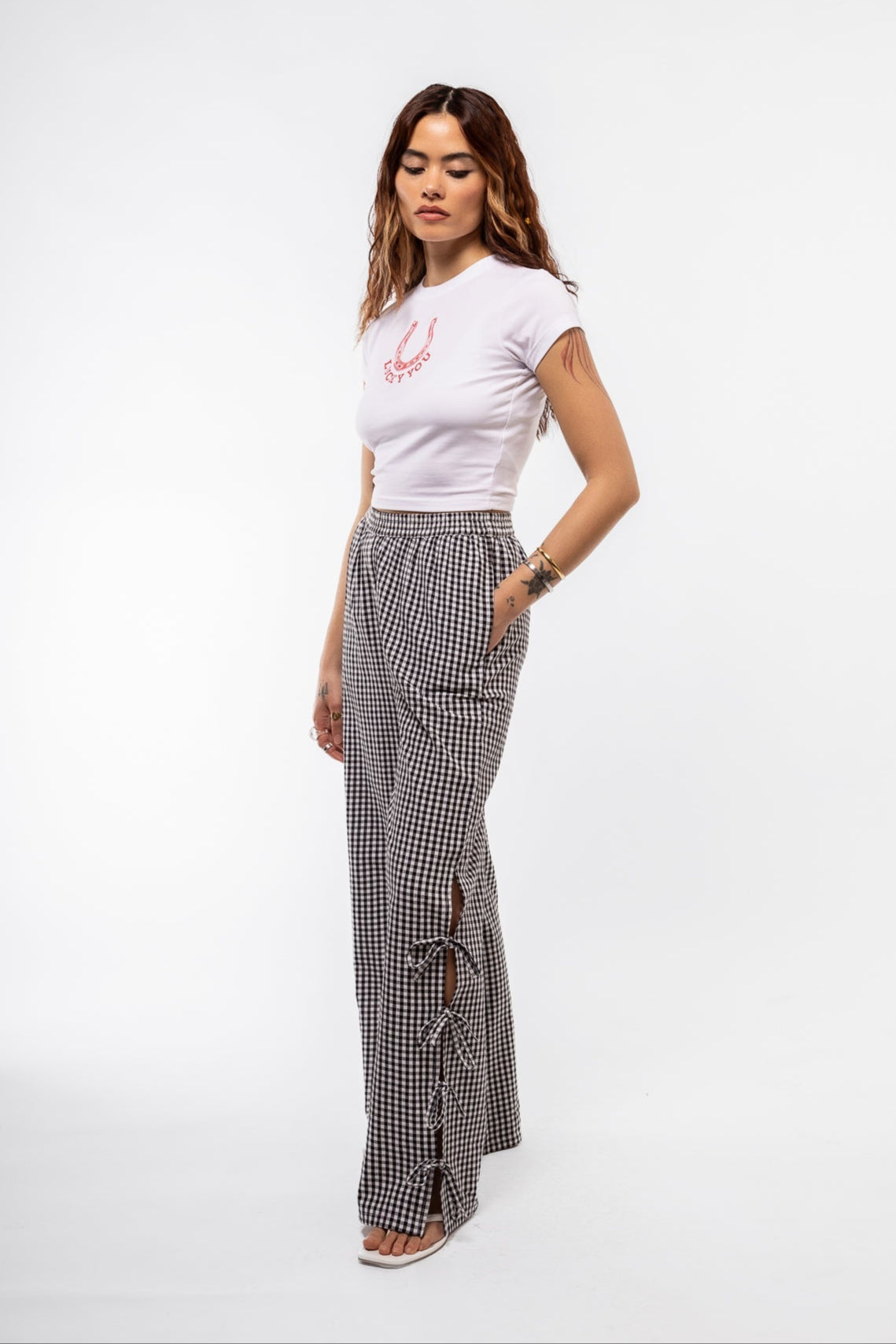 side view of the black gingham trousers with a side details bows
