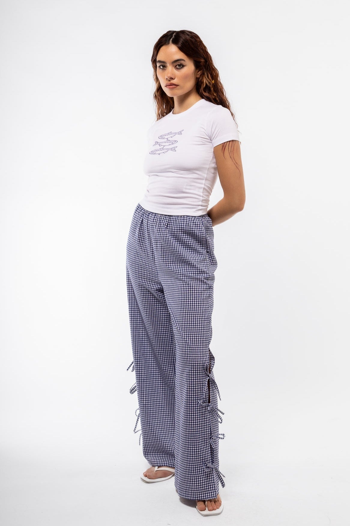 side view of the blue gingham side detail trousers with bows