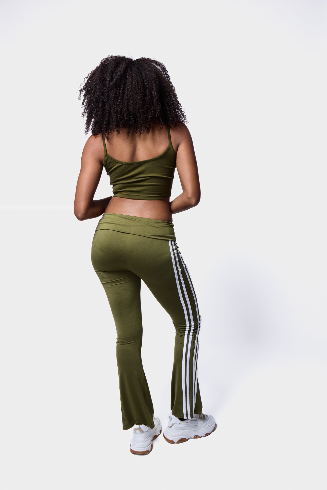model wearing Silkroad Daughters khaki side stripe fold-over flared leggings