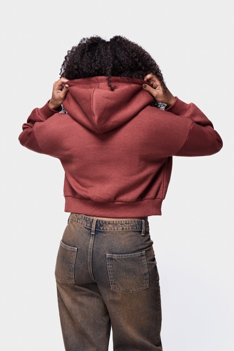 A sleek henna zip-cropped hoodie that combines comfort with contemporary fashion.