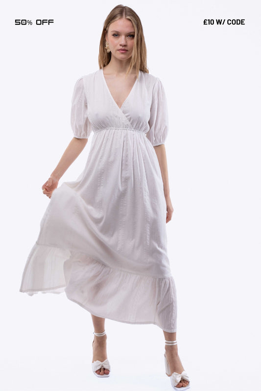 Woman wearing a white dress on a white background with promotional text.