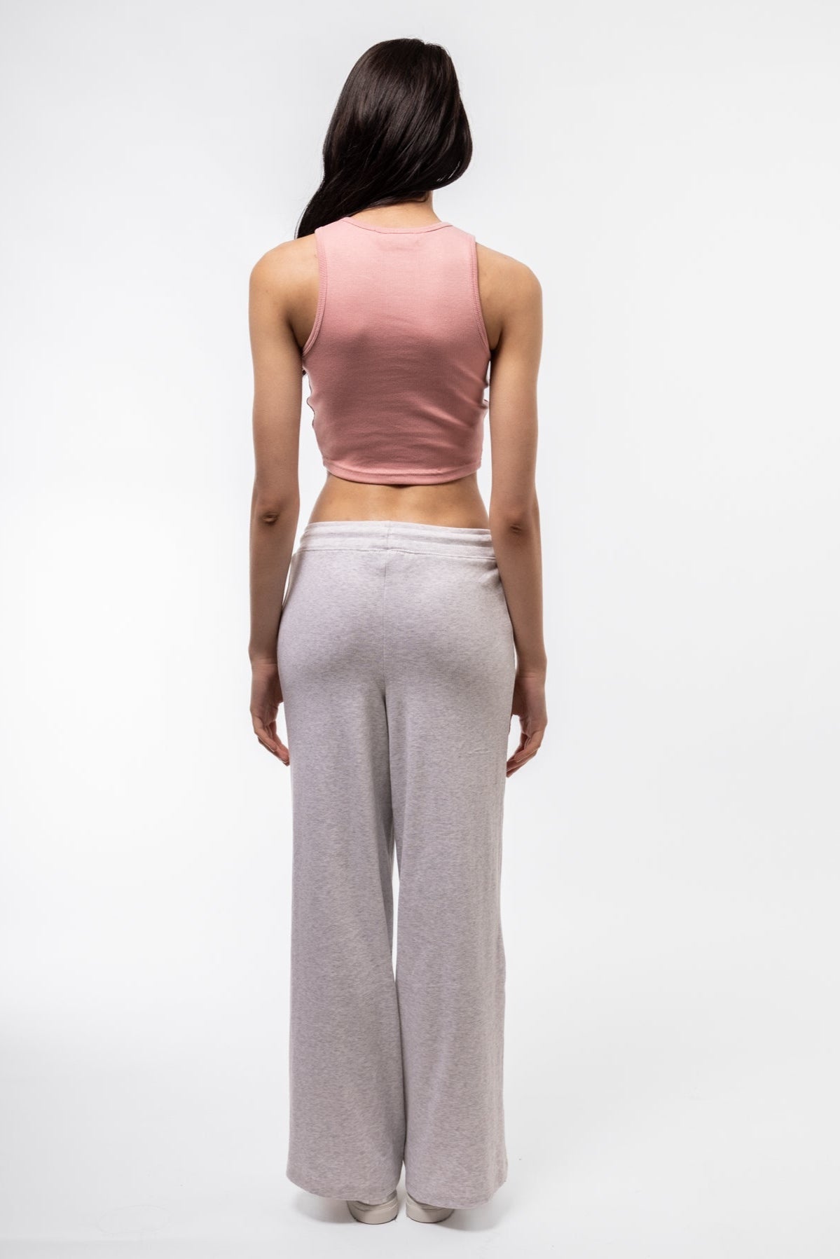 Baby pink racerback top with minimal back panel and fitted style.

