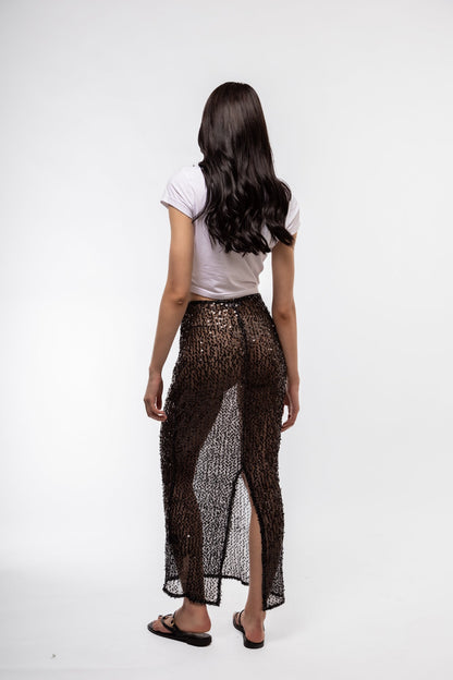 Back profile of glam knit midi skirt with light-catching sequins

