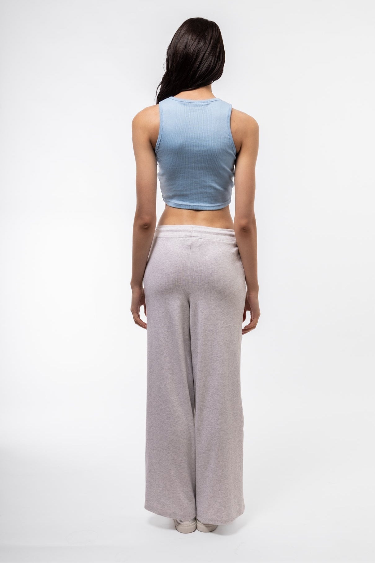 Back shot of blue sleeveless racer top with athletic-inspired design.

