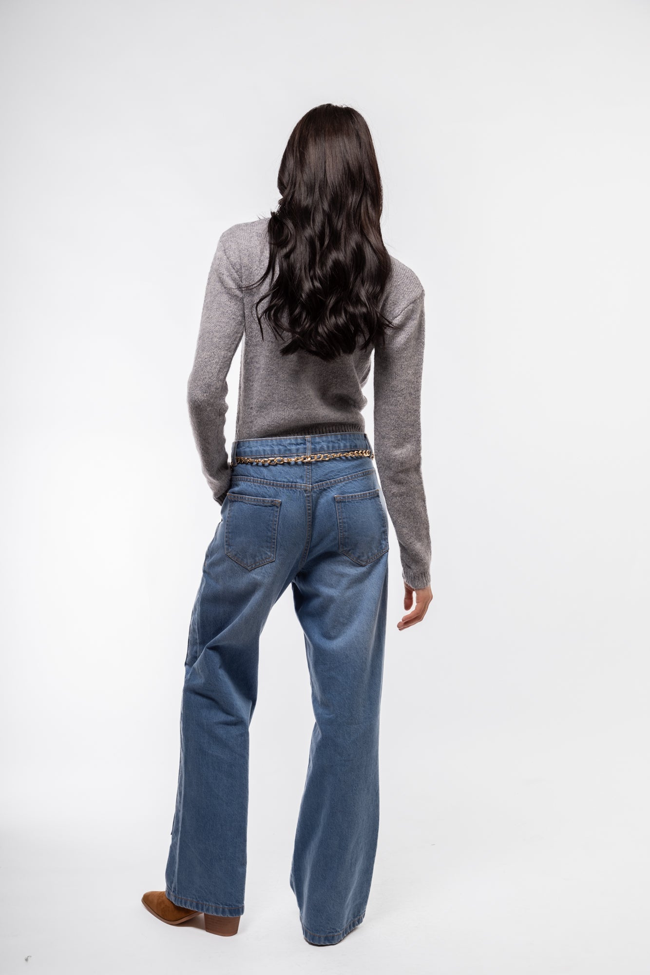 Back view of black crew neck cardigan – smooth knit finish

