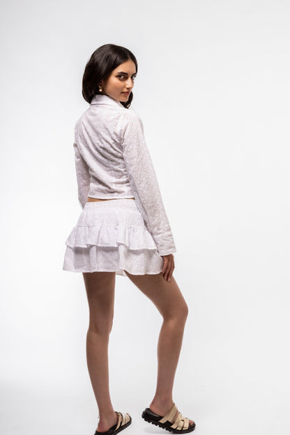 
Back view of broderie frill skirt – tiered silhouette with embroidery

