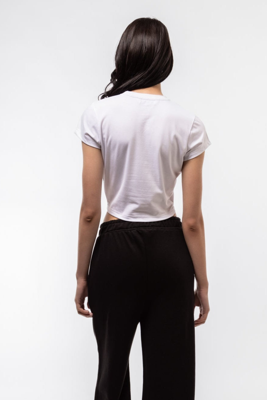 Back view of fitted Feral tee highlighting smooth jersey texture and classic baby tee cut

