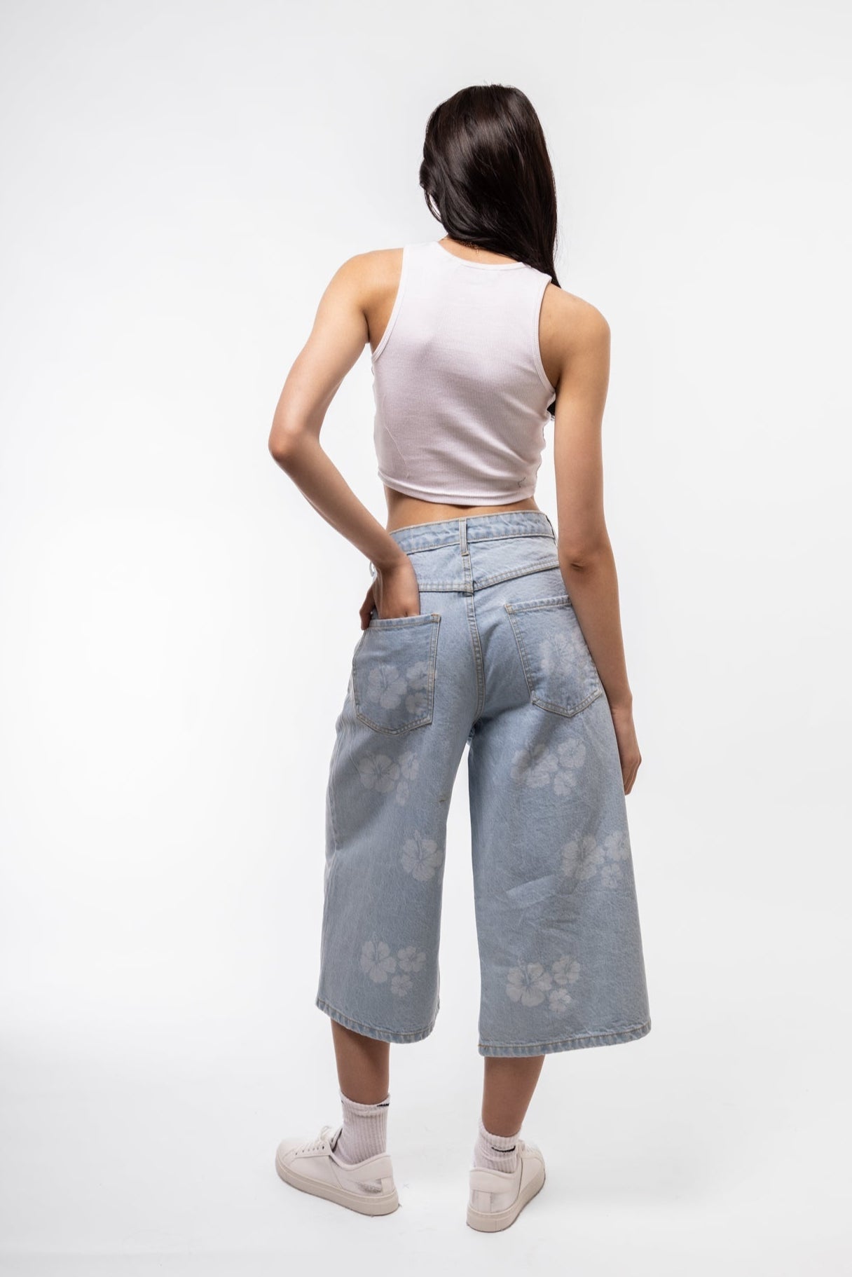 Back view of longline printed denim jorts showing printed back pockets and relaxed fit.

