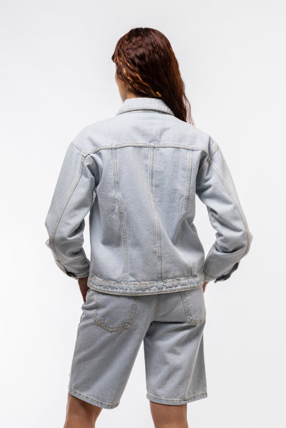 Back view of silver-studded jacket highlighting structured shape and casual cool-girl edge

