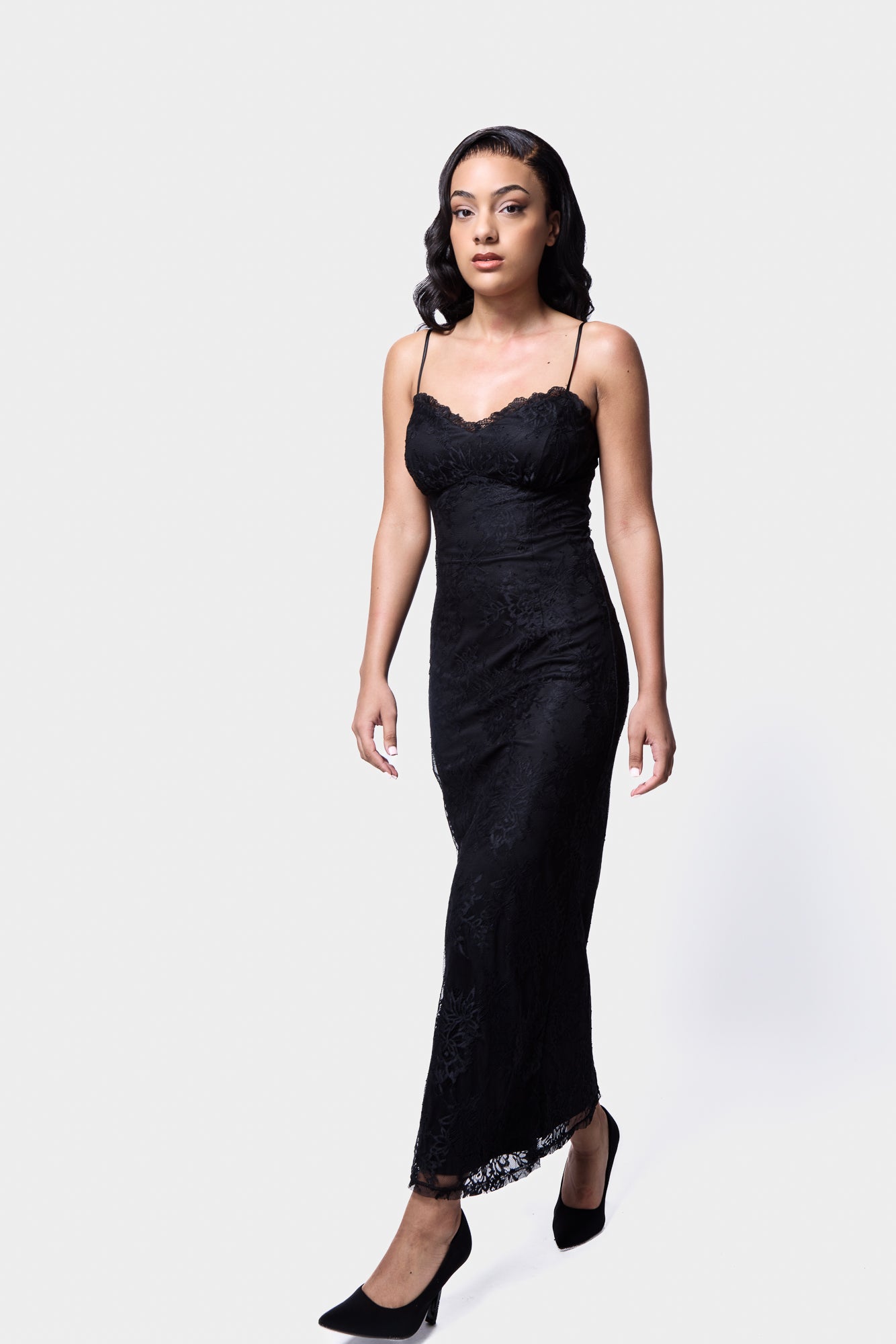 Black lace slip dress with a midi length and elegant floral lace pattern
