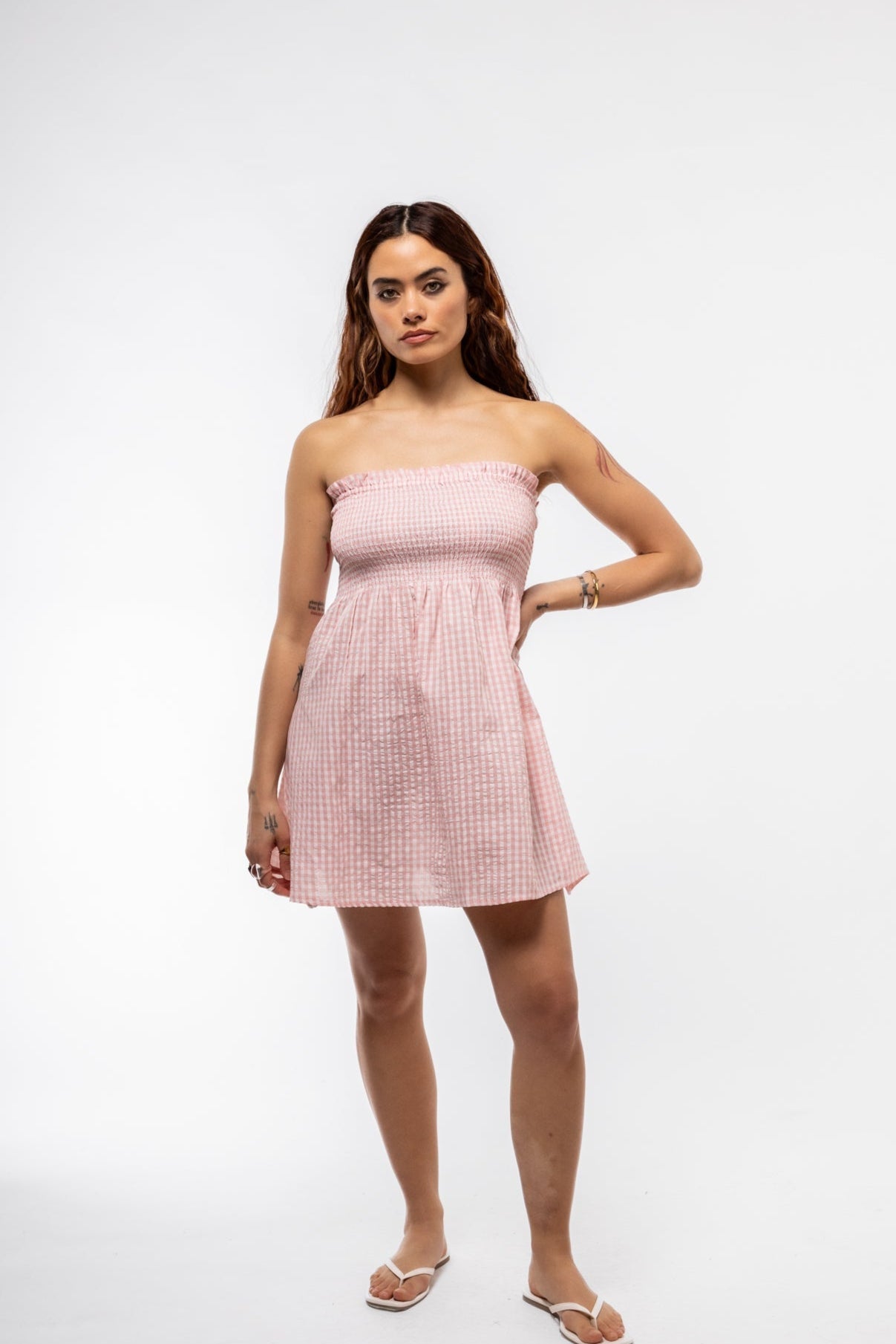 Blush pink bandeau mini dress with plaid print and ruching – front angle


