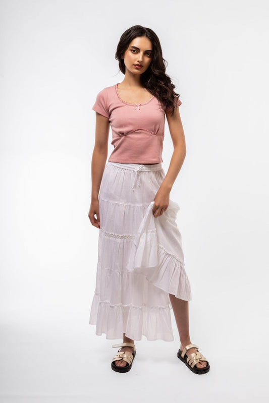 Casual side angle of white boho skirt displaying tiered ruffles and soft texture

