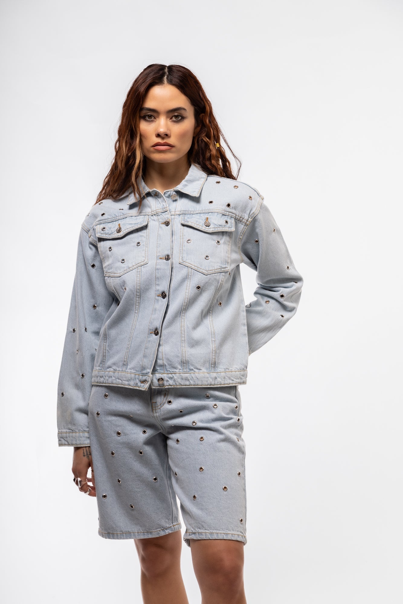 Classic denim jacket with silver stud detailing, chest flap pockets, and structured silhouette

