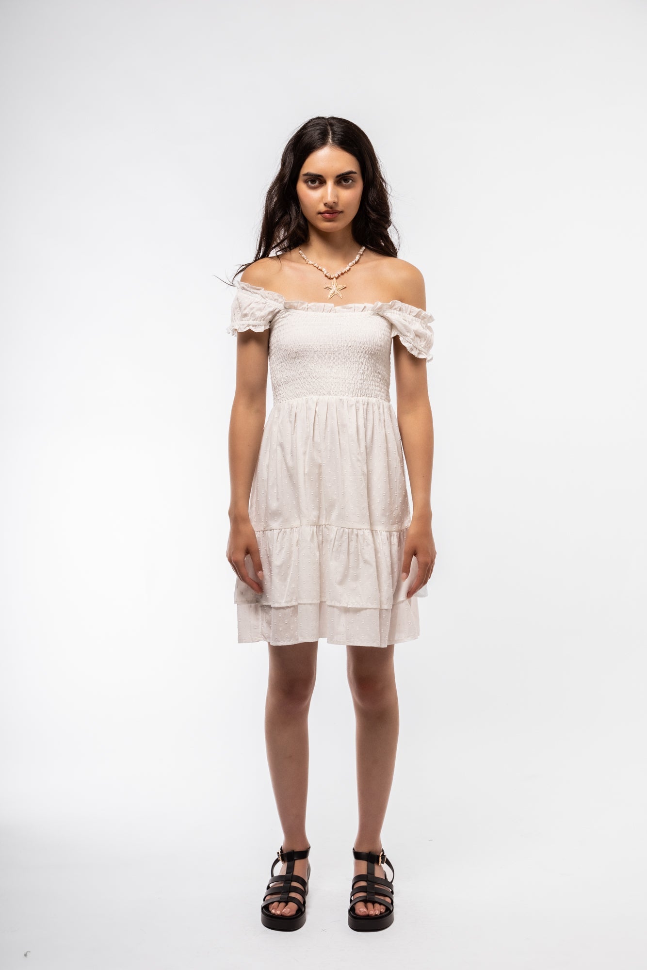 Front-facing view of white smocked midi dress with airy fit and romantic sleeve design.

